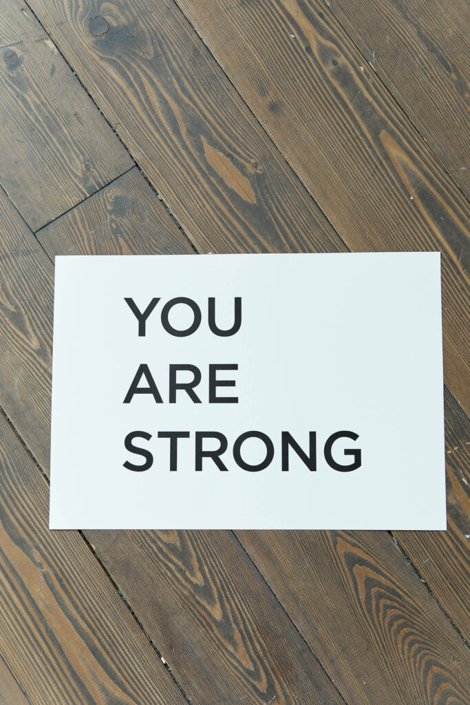 YOU ARE STRONG Motivational Mobile Wallpaper on Rustic Wooden Background