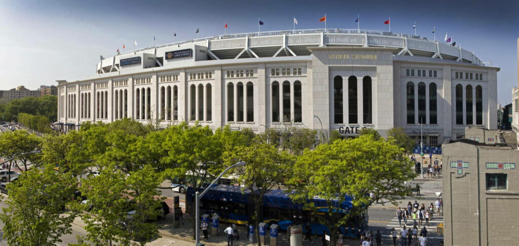 Yankee Stadium Gate 5: Lively Scene Amidst Trees - Wallpaper Background