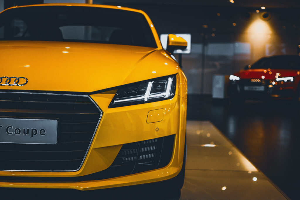 Close-up of yellow Audi TT headlight and bold front design perfect for Audi wallpaper background