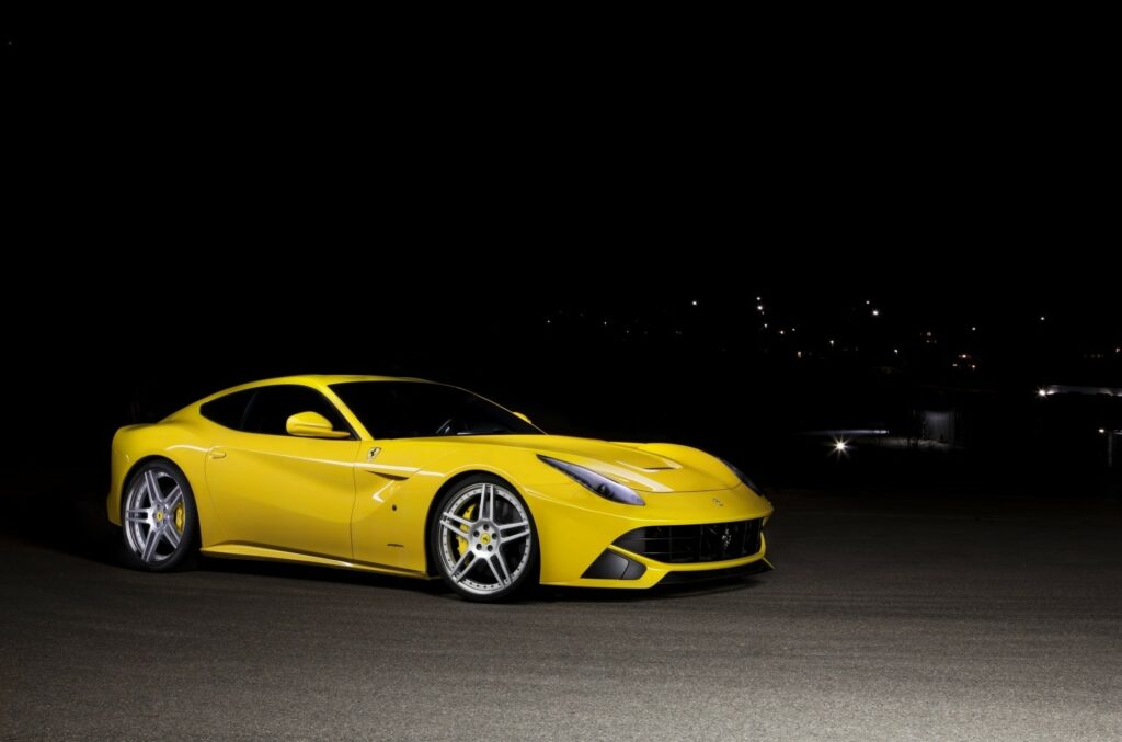 Stunning Yellow Ferrari F12 Berlinetta Side View on Dark Background Wallpaper