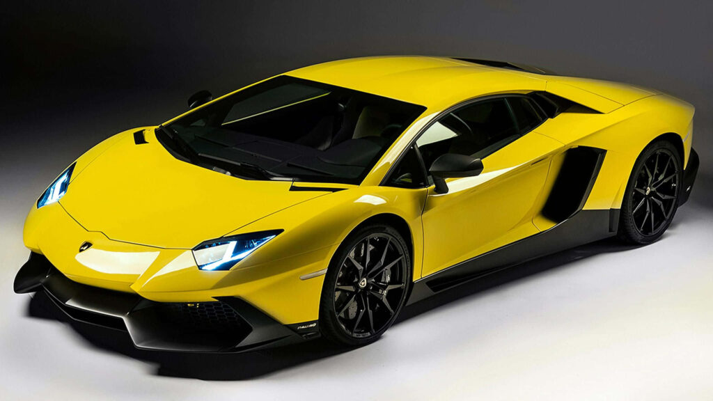 Yellow Lamborghini sports car with sleek aerodynamic design on dark wallpaper background