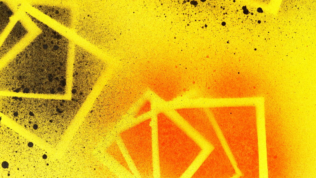 Vibrant psychedelic graffiti wallpaper with bright yellow orange spray paint and black splatter diamonds