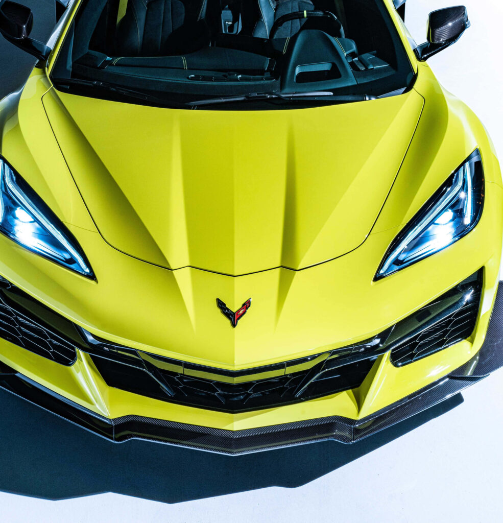 Yellow sports car front view with aggressive headlights and sharp aerodynamic lines wallpaper