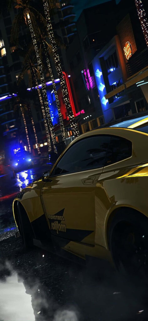 Yellow sports car racing through neon city streets at night in Need for Speed Heat wallpaper
