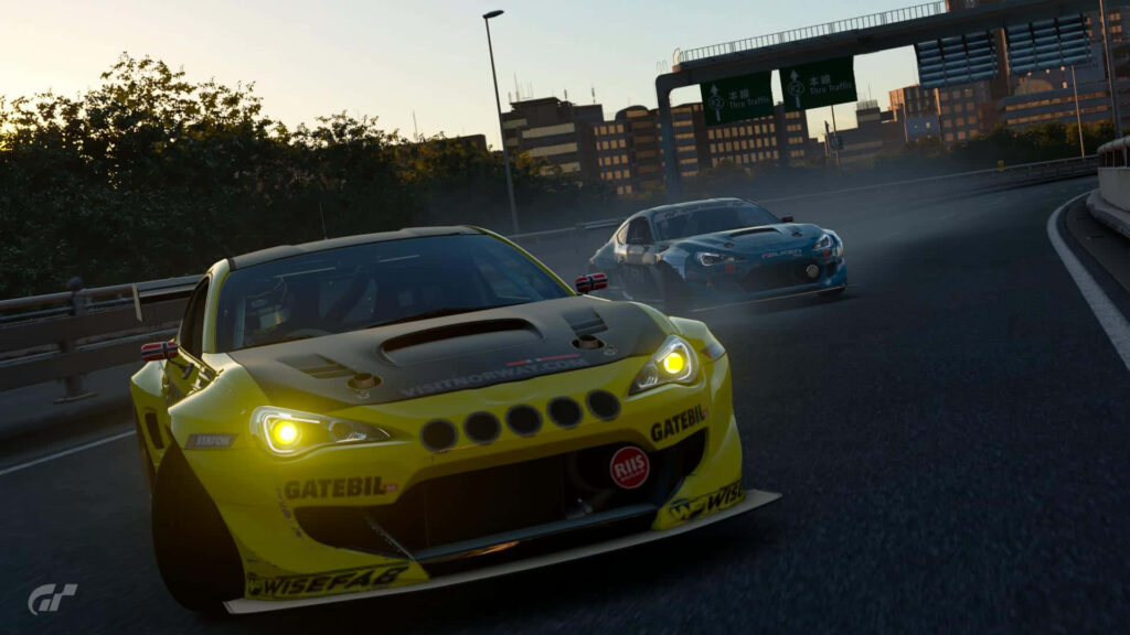 Bright yellow sports car racing through city road with a trailing car in urban landscape wallpaper