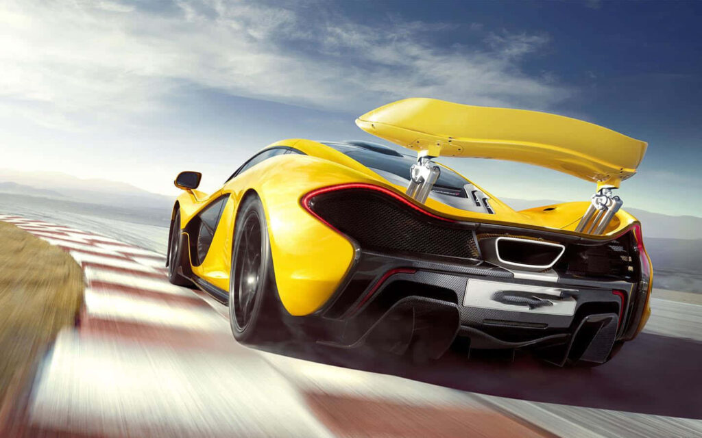 Yellow sports car racing on winding track with aerodynamic design and dynamic spoiler background Wallpaper