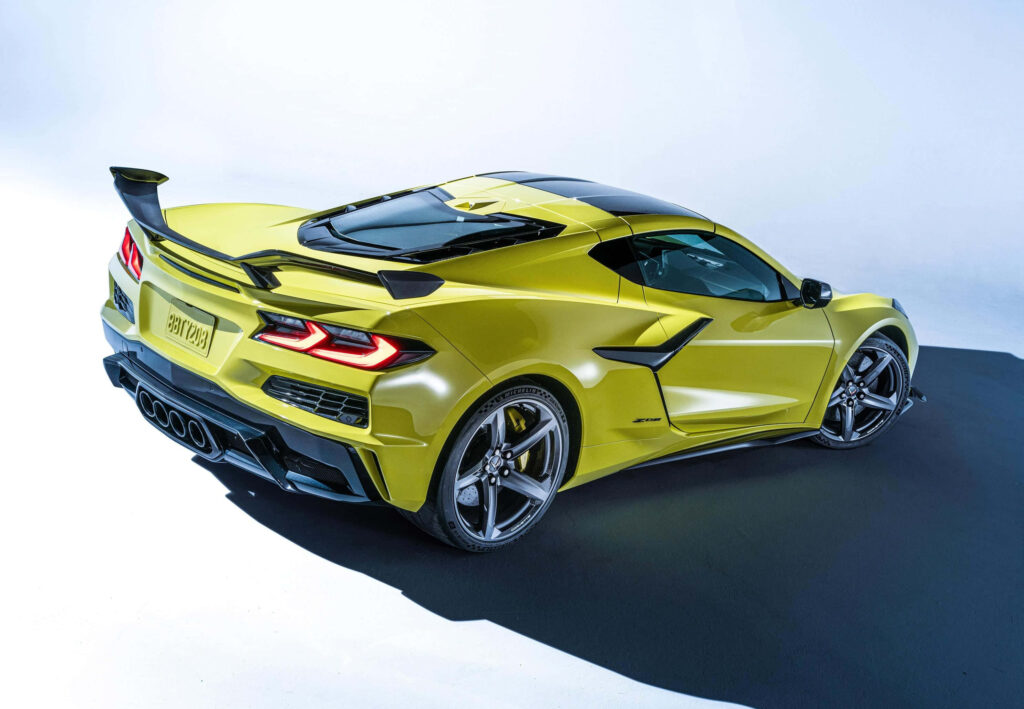 Yellow sports car with aerodynamic design aggressive spoiler and sleek high-performance lines background Wallpaper