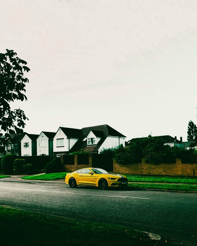Stunning Yellow Sports Car Wallpaper in Suburban Setting