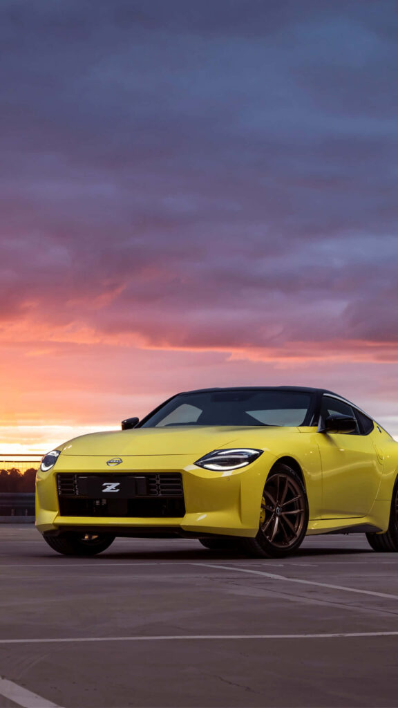Yellow sports car on rooftop at sunset vibrant sky speed modern elegance wallpaper background