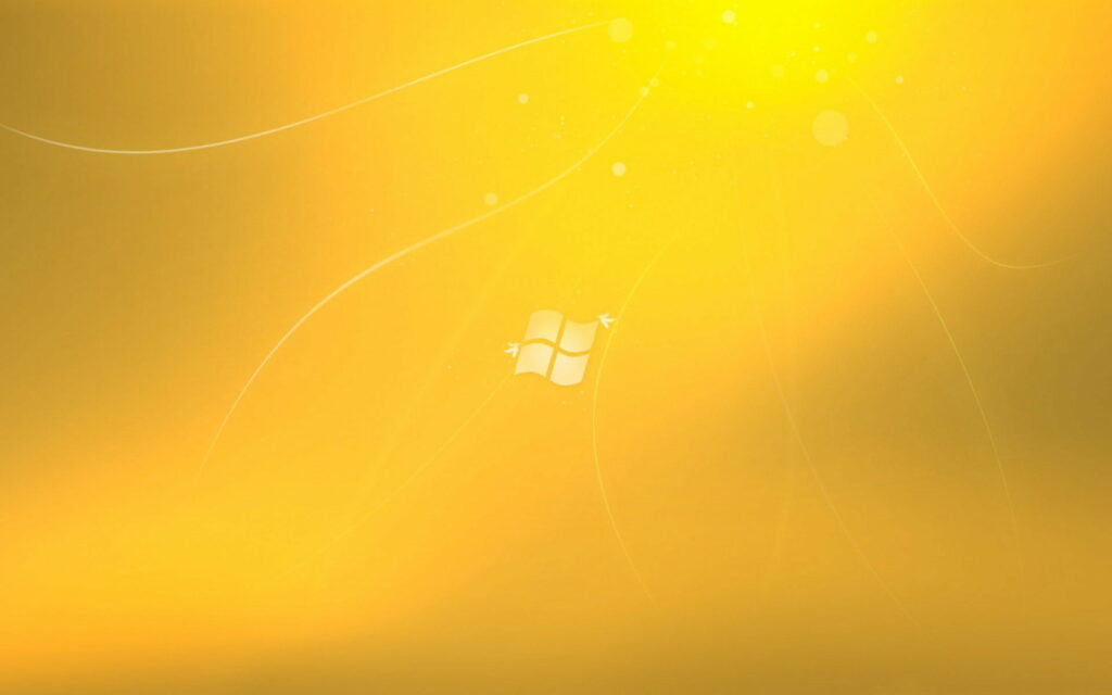Vibrant golden yellow Windows 7 wallpaper with glowing orbs and flowing abstract curves background