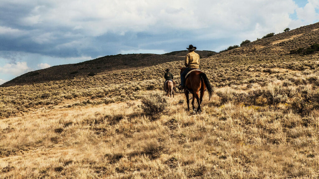 Yellowstone-Inspired Scenic Wallpaper: Riders in Golden Mountain Landscape
