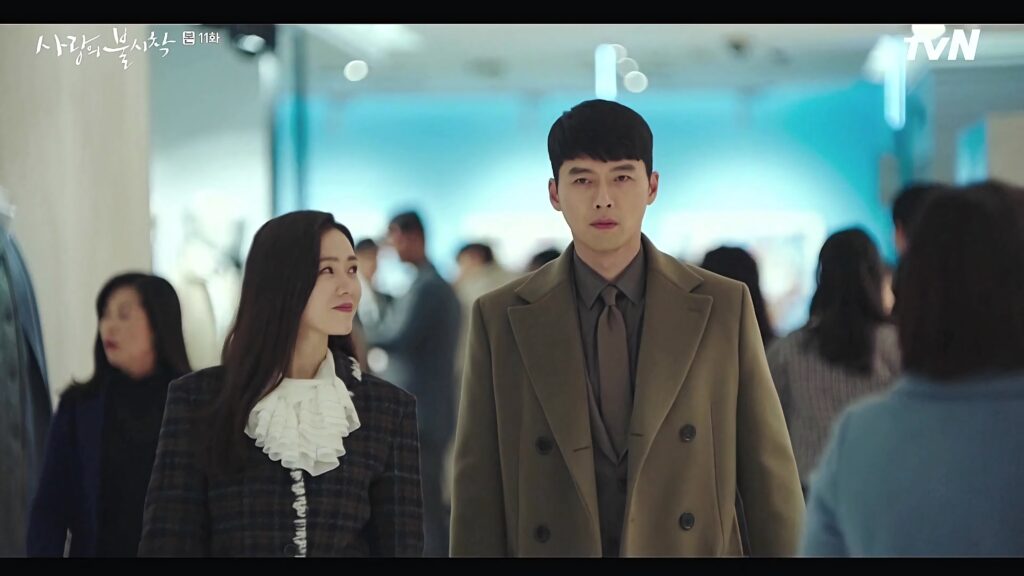 Yoon Se ri and Ri Jeong hyeok walking in stylish train station scene Crash Landing On You wallpaper