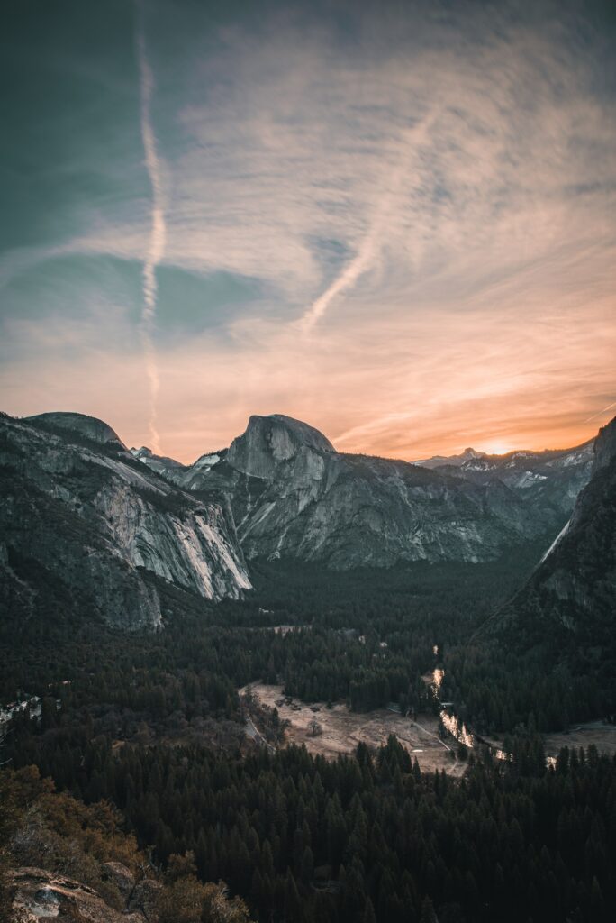 Yosemite Valley sunset with granite cliffs forested valleys and reflective river landscape wallpaper