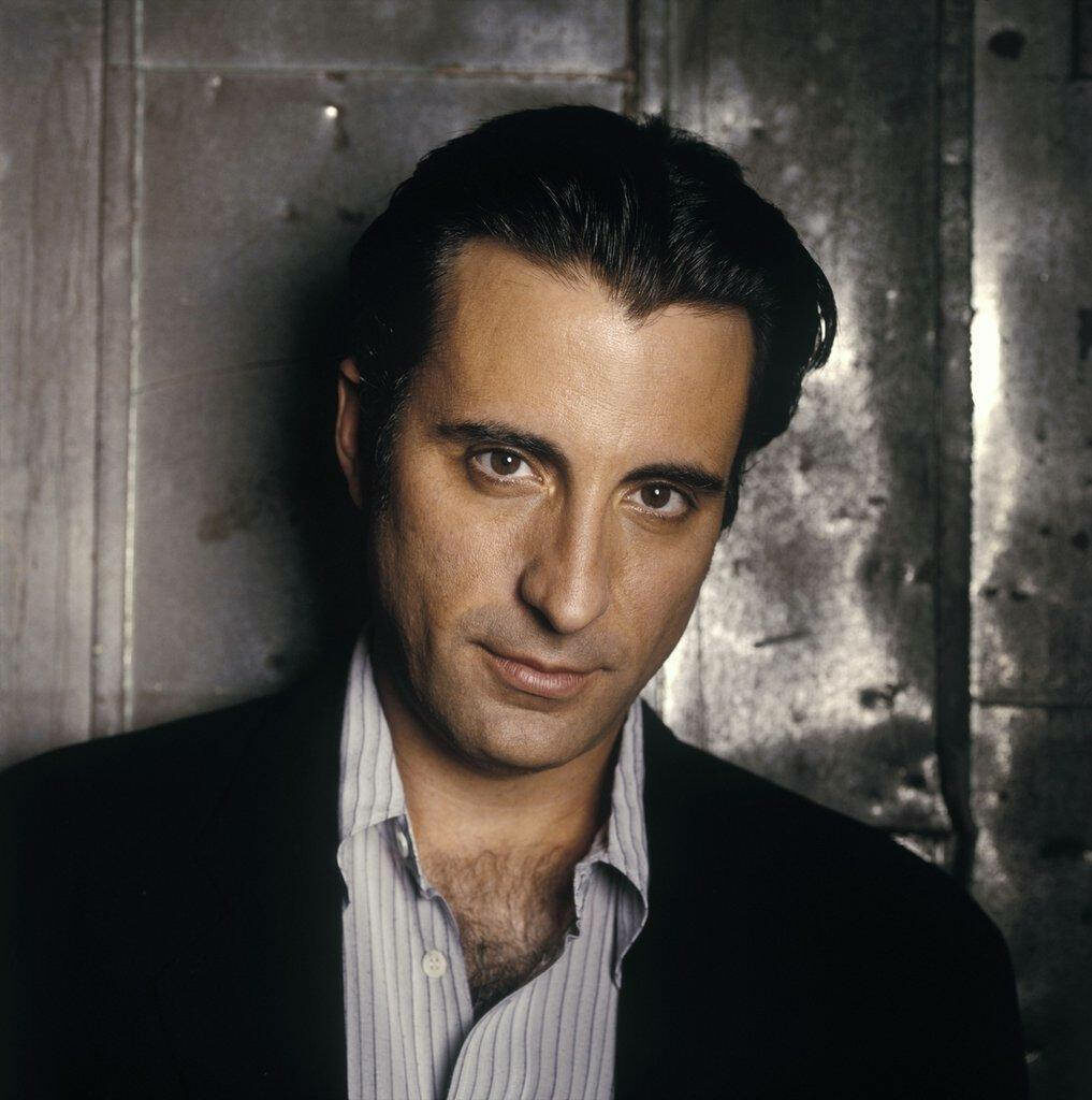 Young Andy Garcia portrait in classic suit intense charming expression textured background Wallpaper