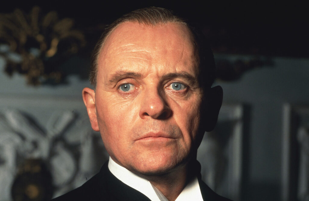 Young Anthony Hopkins intense gaze classic style formal setting wallpaper background image