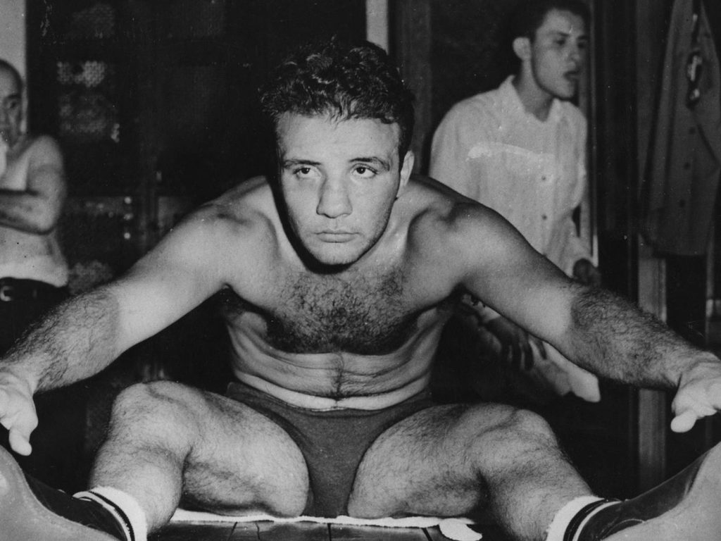 Young Jake LaMotta focused stretching in black and white intense boxing training session wallpaper