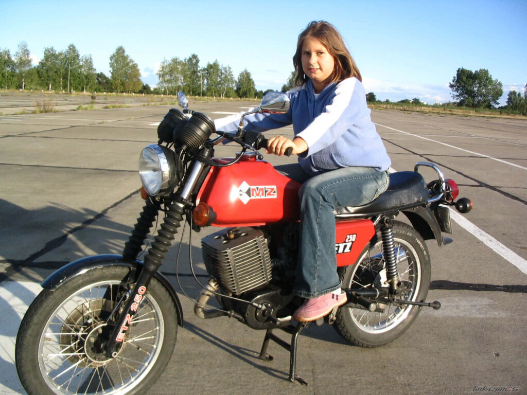 Young Rider on Classic Red KMZ Motorcycle - Freedom Wallpaper