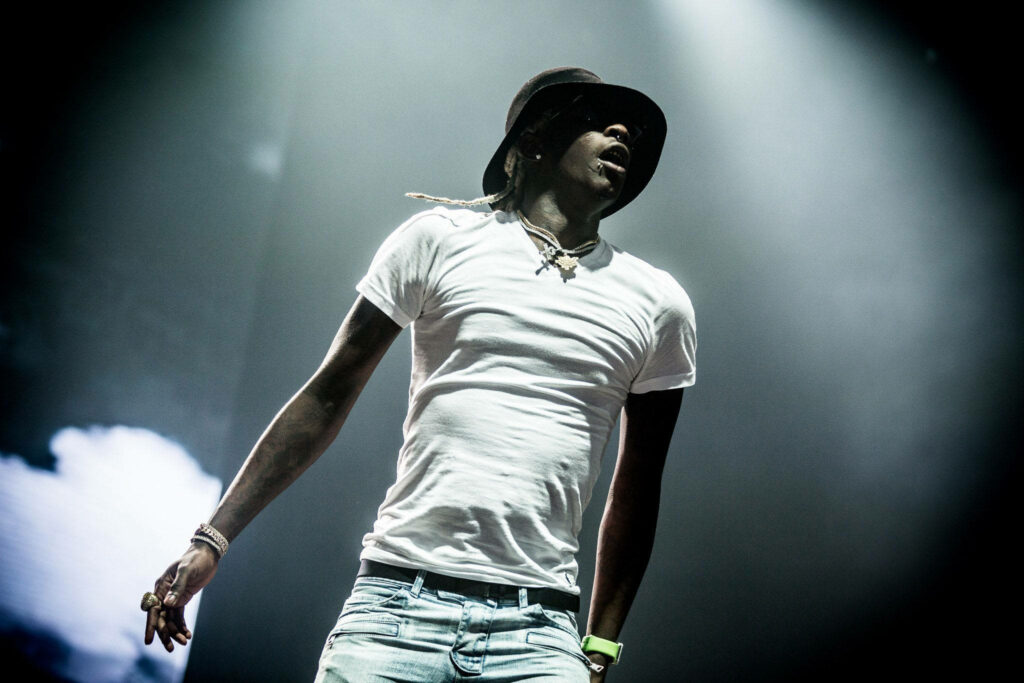 Young Thug Energetic Performance in White T-Shirt & Hat Wallpaper