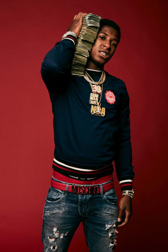 YoungBoy Never Broke Again in navy sweatshirt with gold chains and cash on red background wallpaper