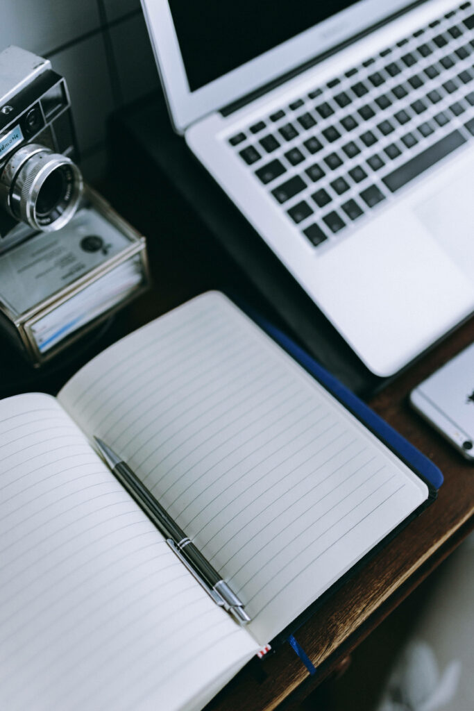 Productivity Oasis: A Motivational Work Desk with Tech Essentials and Creative Tools Wallpaper