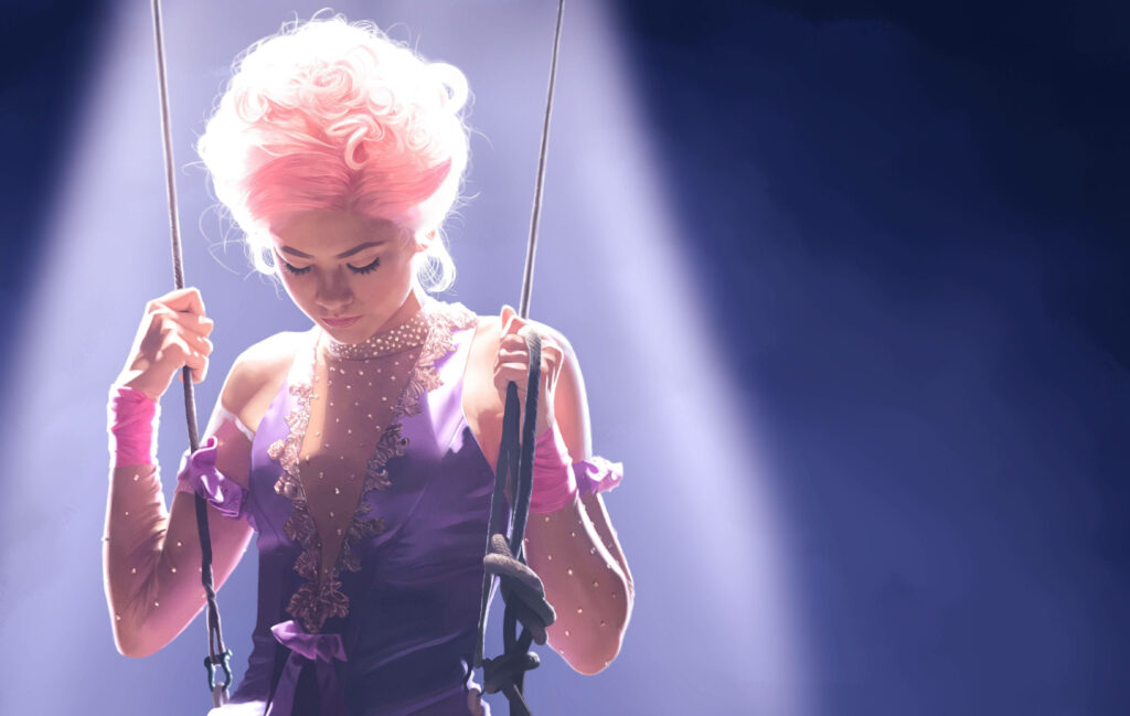 Zendaya in glamorous circus costume from The Greatest Showman with dramatic elegant lighting Wallpaper