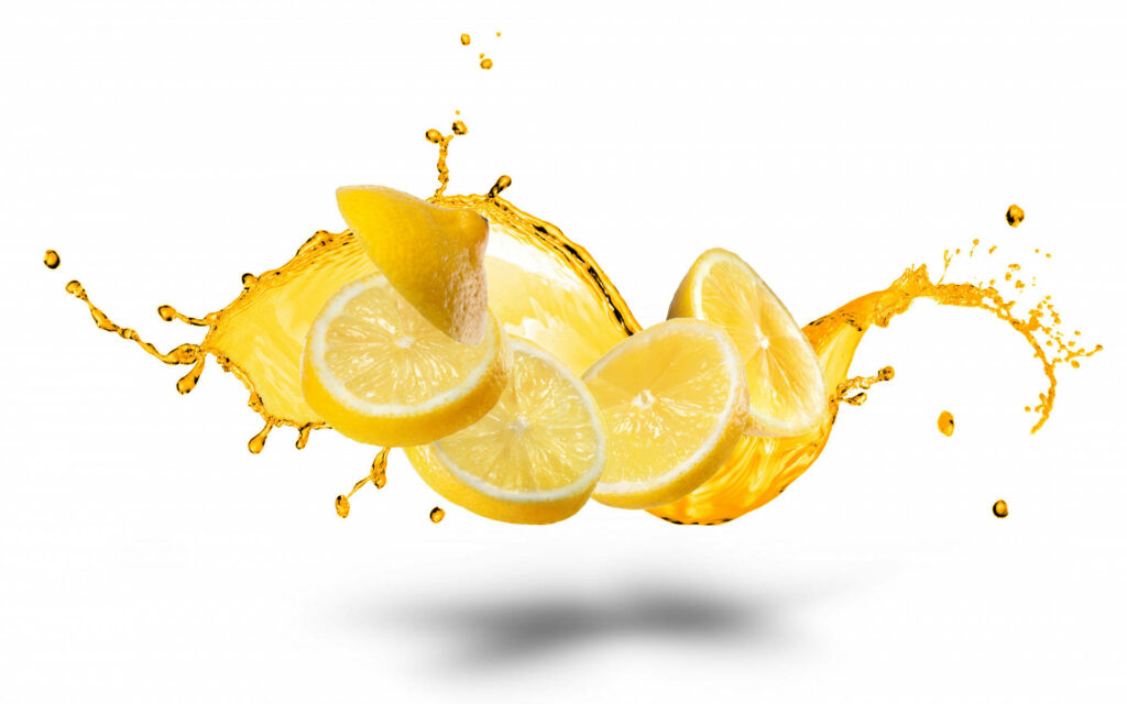 Zesty Artistry: Vibrant Citrus Slices and Golden Juice Dance on a Clean Canvas Wallpaper