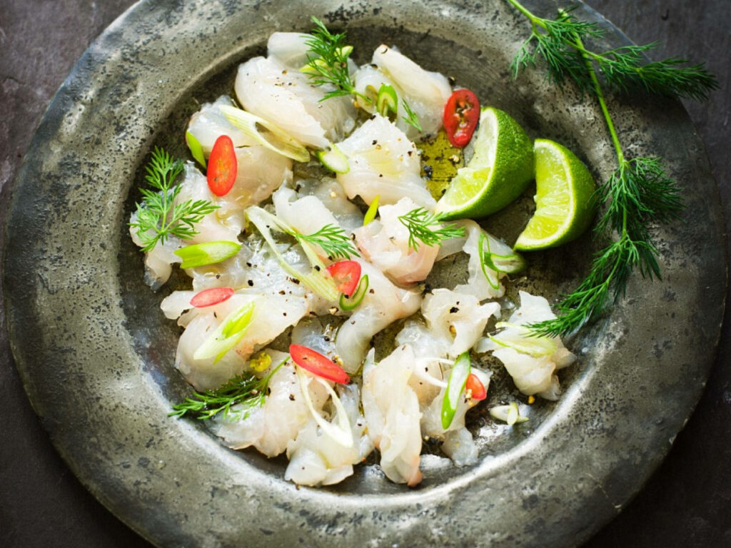 Vibrant ceviche with raw fish red chili dill lime and onions on rustic stone platter wallpaper background