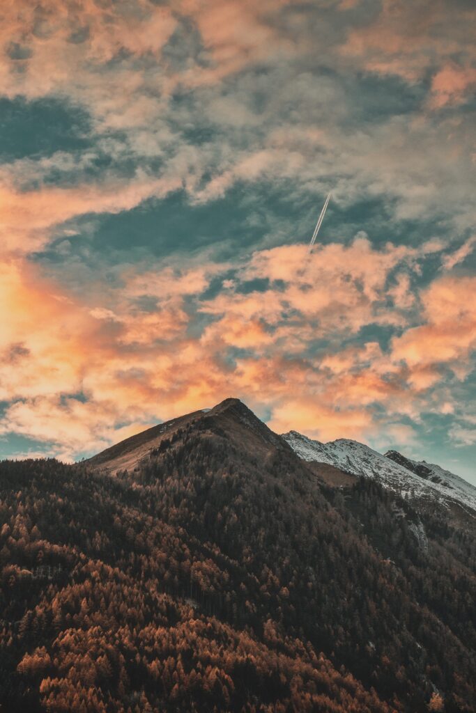 Zillertal Alps Italy autumn forest rugged mountain peaks dramatic orange blue sky wallpaper