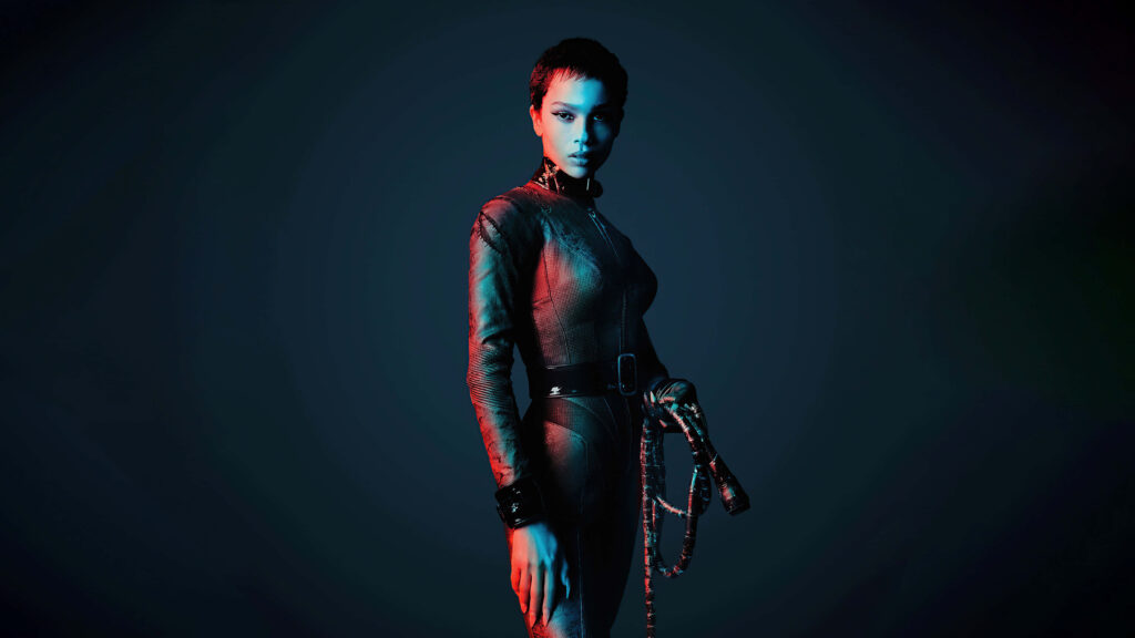 Zoe Kravitz in sleek leather outfit under dramatic blue and red lighting stylish wallpaper background