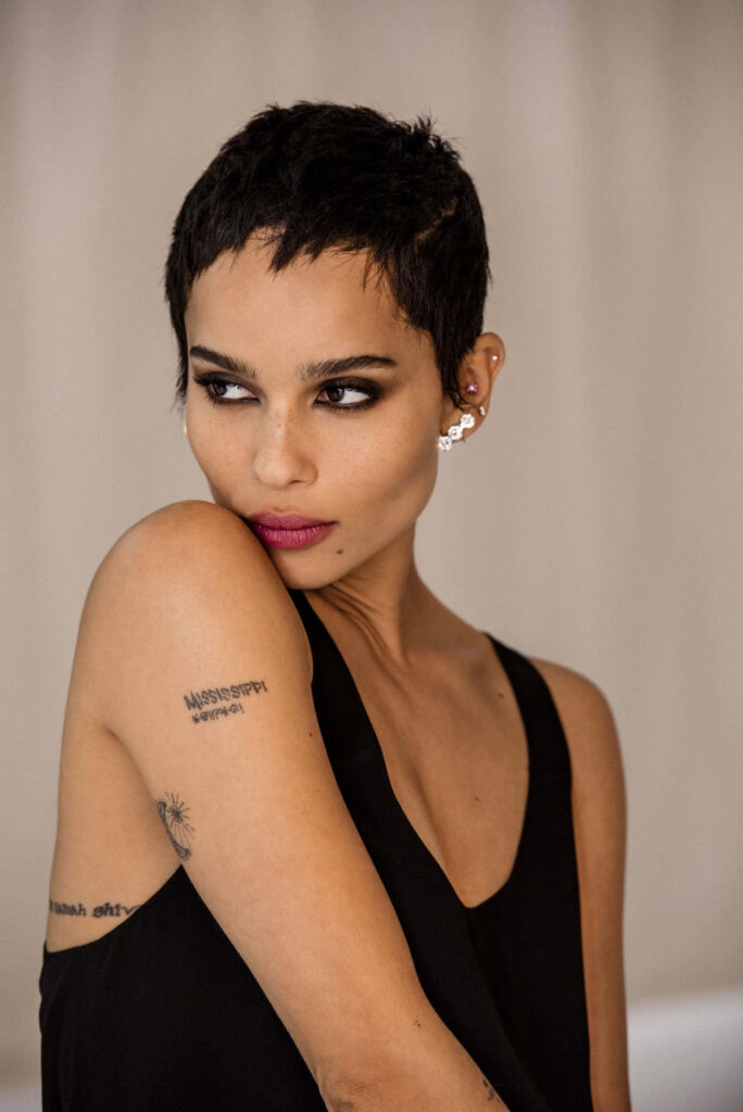 Elegant portrait of Zoë Kravitz showcasing chic style in minimalist wallpaper background