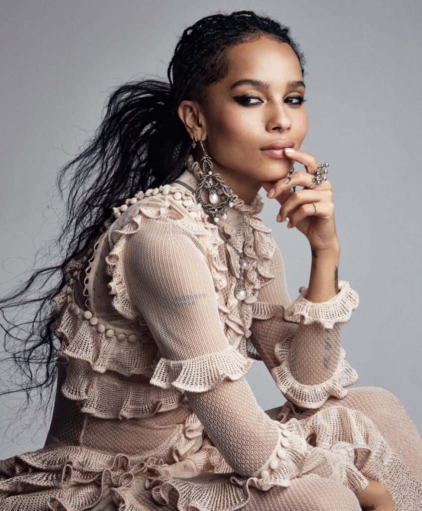 Zoë Kravitz elegant portrait wallpaper with intricate jewelry and textured stylish outfit background