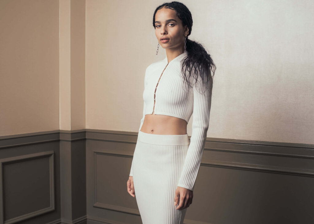 Zoë Kravitz in elegant white ribbed cropped top and skirt modern sophisticated portrait wallpaper