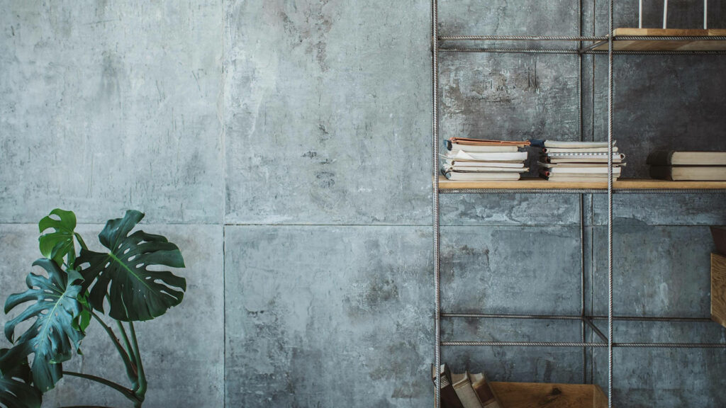 Professional Zoom background with grey concrete wall rebar shelf books and vibrant Monstera plant Wallpaper