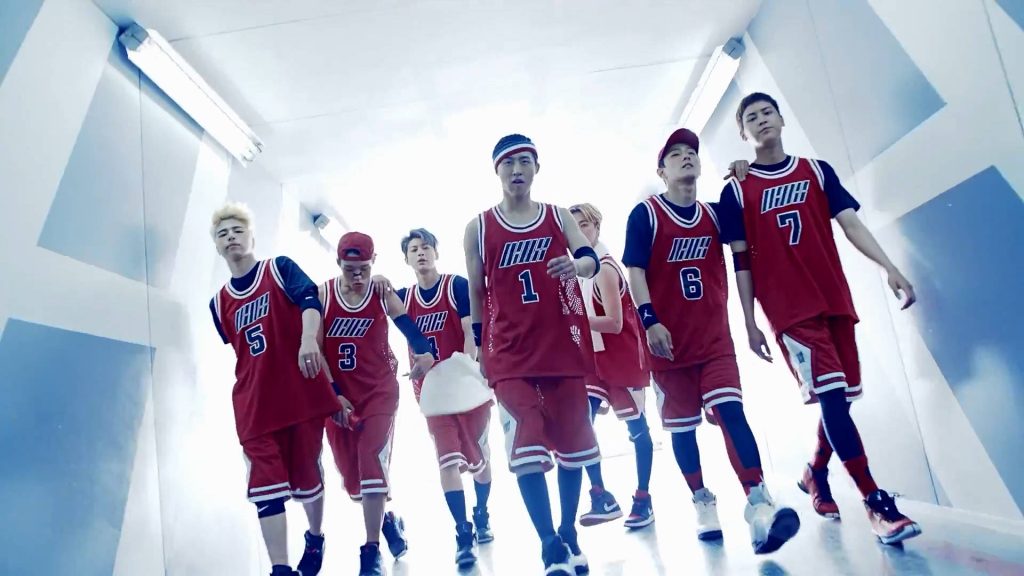 iKON K-pop group walking in red jerseys in bright corridor stylish sporty wallpaper background