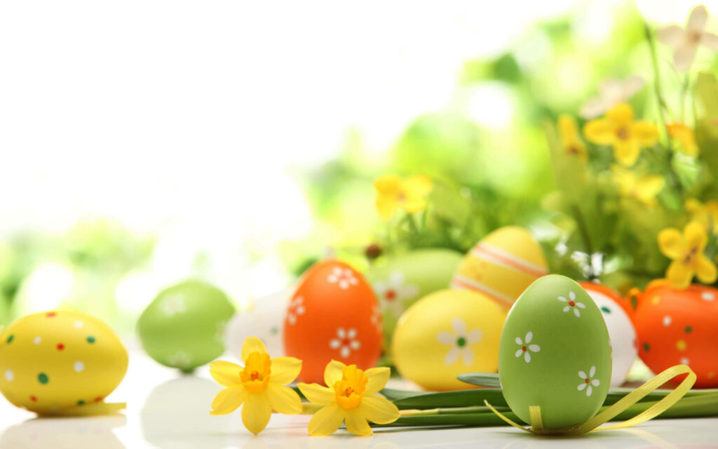 Egg-citing Easter Delight: A Floral Assortment of Joyful Egg Designs on a White Wallpaper!